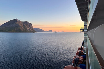 View from the balcony of a cruise ship at sunset in a fjord in Norway