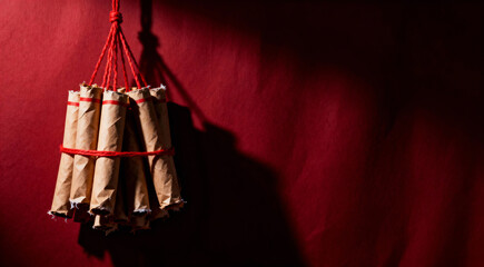  Bundle of Firecrackers Resembling Dynamite Hanging on a Red Wall