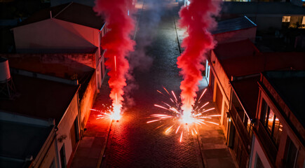 Red Smoke Flares with Sparks Burning on a City Street at Night