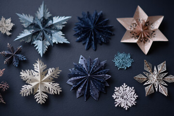 Collection of paper snowflakes various designs and colors perfect for holiday crafts and seasonal decorations