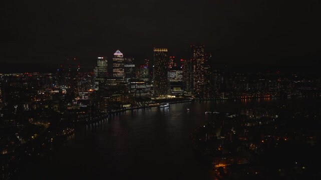 Aerial view of Canary Wharf at night. London financial district illuminated with city lights