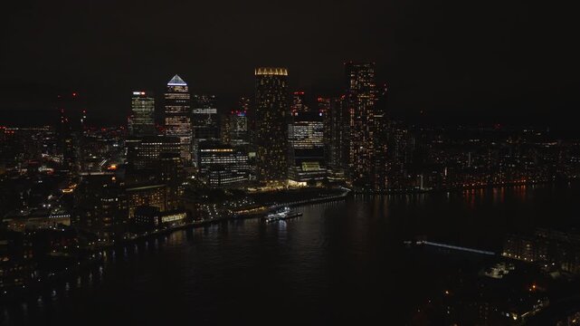 Aerial view of Canary Wharf at night. London financial district illuminated with city lights