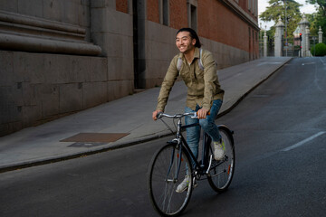 Fototapeta premium Young asian man biking in urban street