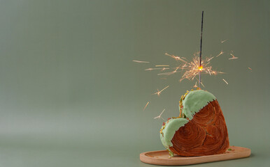 Shiny festive candle sparkler birthday celebration holiday Delightful and vibrant heartshaped pastry croissant treat, beautifully topped with colorful frosting nut galore. Mock up template copy space