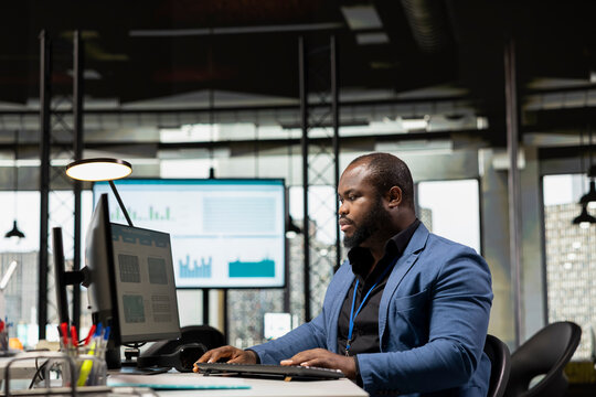 Black office consultant reviewing performance metrics and monthly reports, preparing business vision for greatness within the corporate environment. Management strategy for innovation.