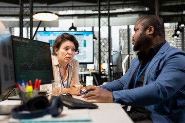 Manager and assistant reviewing monthly data charts to create reports, applying business strategy and analysis to drive innovation and improve company performance. Work alliance.