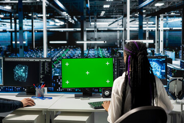 Engineer in data center using green screen computer, optimizing hardware for AI tasks, increasing workloads. Server hub IT worker automating system diagnostics using deep learning on mockup PC