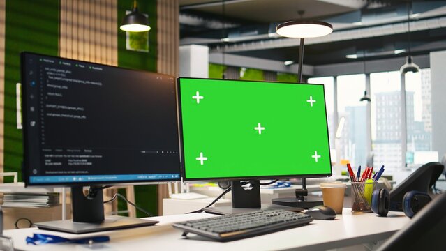 Mockup PC in empty IT startup office displaying programming languages used for building applications. Green screen computer showing code in software development agency with no people in