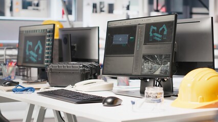 PC on desk in empty photovoltaics factory used for data analysis and reviewing system metrics for the production line. Computer screen in solar panels plant troubleshooting technical issues.