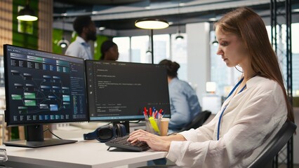 Cheerful startup manager satisfied with progress oj junior dev learning how to use machine learning tech. Team leader doing fist bump with intern in office, satisfied with work done, camera A