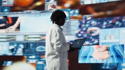 Professional doing scientific research, analyzing virus structure on laptop to support vaccine development. Biomedicine specialist reviewing viral mutation models on notebook using software - Powered by Adobe