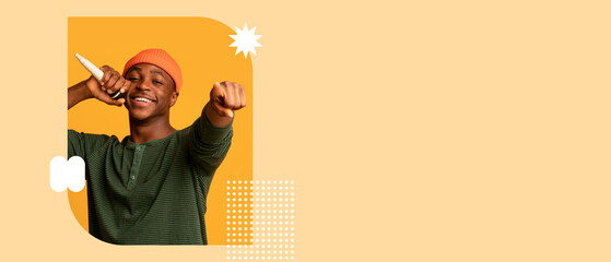 A young man poses cheerfully with a microphone, wearing a green striped shirt and orange beanie. The colorful background enhances the lively mood, capturing a sense of joy and creativity.