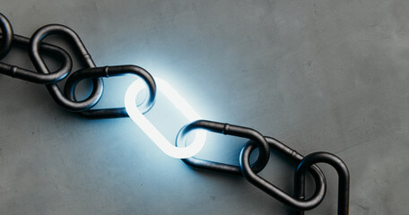 A single illuminated link shining in a dark metal chain on a concrete background, a symbol of power...