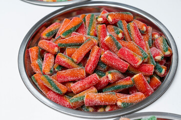 Snack bar cart with colorful and flavored candies and sweets, marshmallows, and fruit jellies for parties and events to serve in small cups.
