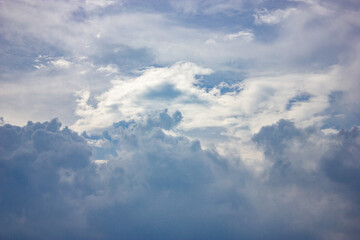 Obraz premium Combination of thick white clouds and soft blue sky creating a calm yet dynamic atmosphere. The layered cloud formations add natural depth and beauty, perfect for weather or nature backgrounds.