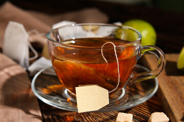 Cup of hot tea on wooden background
