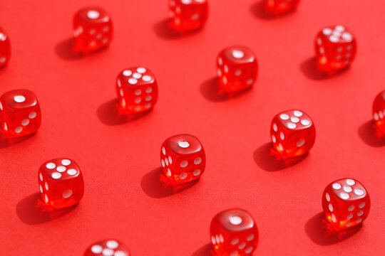 Many game dices on red background