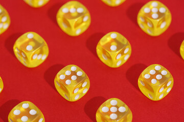Yellow game dices on red background