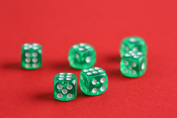 Green game dices on red background