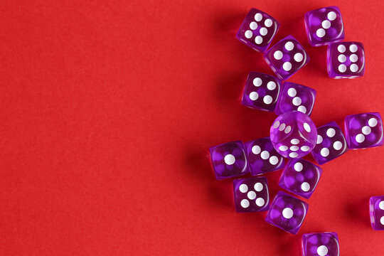 Purple game dices on red background