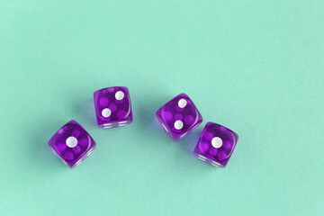 Purple game dices on turquoise background