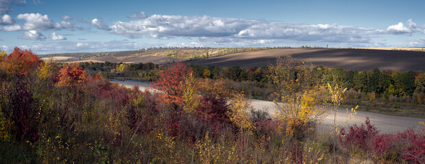 A mesmerizing autumn scene.
All the colors of autumn in a panoramic view of a rugged landscape.
