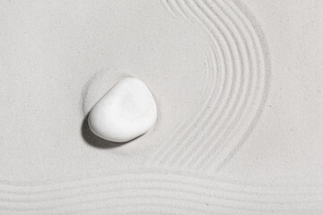 Spa stone on light sand. Zen concept