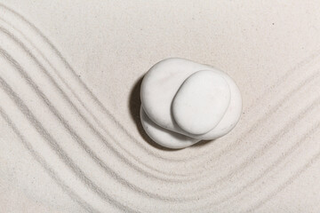 Spa stones on light sand with lines. Zen concept