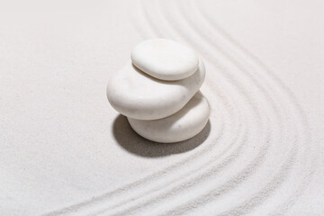 Spa stones on light sand with lines. Zen concept
