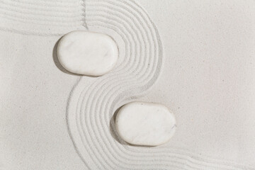 Spa stones on sand with lines. Zen concept