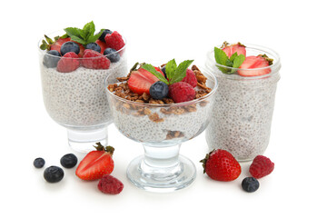 Glasses of tasty chia seed pudding with mint leaves, granola and different berries on white background