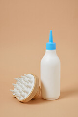 Hair growth product massager on beige background, scalp and baldness treatment, hair loss concept