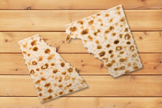Matzah bread jewish food broken into two pieces