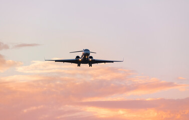 Airplane Flying at Colorful Sunset Sky