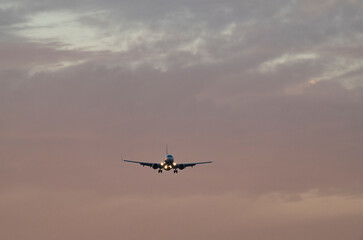 Plane Gliding Through Painted Twilight Skies