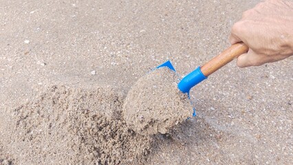 Children are pouring sand on the beach