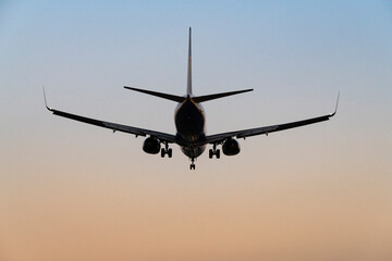 Airliner Landing Amidst Vibrant Sunset Colors