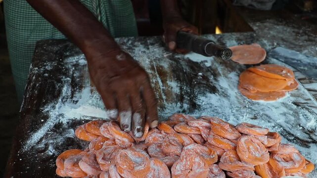 Snacks made of dough are fried in the hot oil of a kadai. Handmade crunchy salty snack food. 