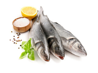 Fresh seabass fish, black peppercorns, basil leaves and bowl with salt isolated on white background, closeup