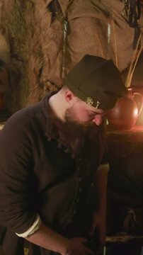 Bearded merchant buys loot from adventurer in tavern. Happy bearded man gives purse with coins to knight trading in store. Dungeons and dragons cosplay