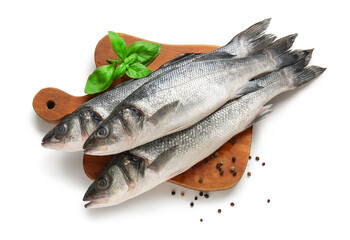 Cutting board with fresh seabass fish and basil leaves isolated on white background, closeup