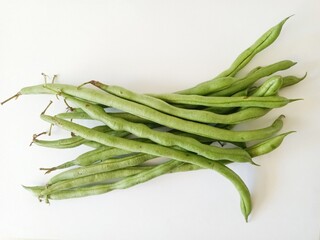 Fototapeta premium Fresh long green beans on white background, closeup of organic vegetables.