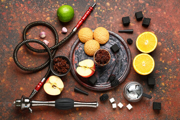 Parts of hookah with tobacco, fruits, berries and cookies on red grunge background
