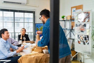 Corporate business team meeting discussion working plan in office room. Asian man employee writing on glass board presentation reusable Eco friendly product to colleague teamwork and project manager.