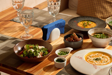 A Beautiful Array of Gourmet Dishes Arranged on a Wooden Table Serving Delightful Meals