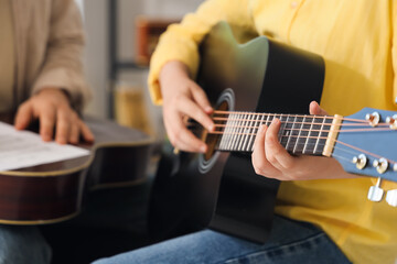 Fototapeta premium Private music teacher giving guitar lessons to boy in room, closeup