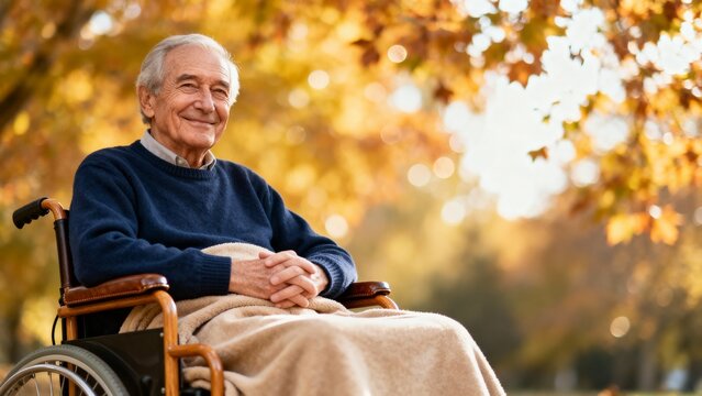 Elderly man smiling while sitting in wheelchair outdoors in autumn - Powered by Adobe