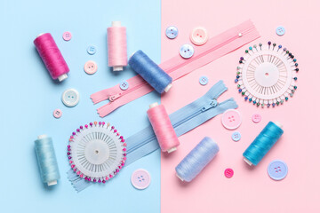 Composition with thread spools, zippers, ball pins and buttons on color background