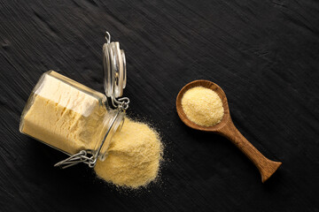 Wheat semolina in a spoon and glass jar - Triticum