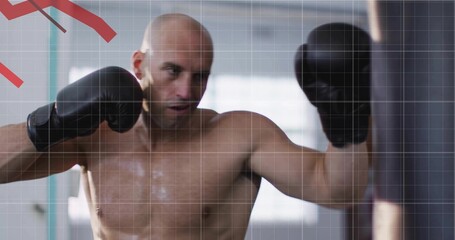 Punching shirtless bald man delivering punch on heavy punching bag in gym, with black boxing gloves